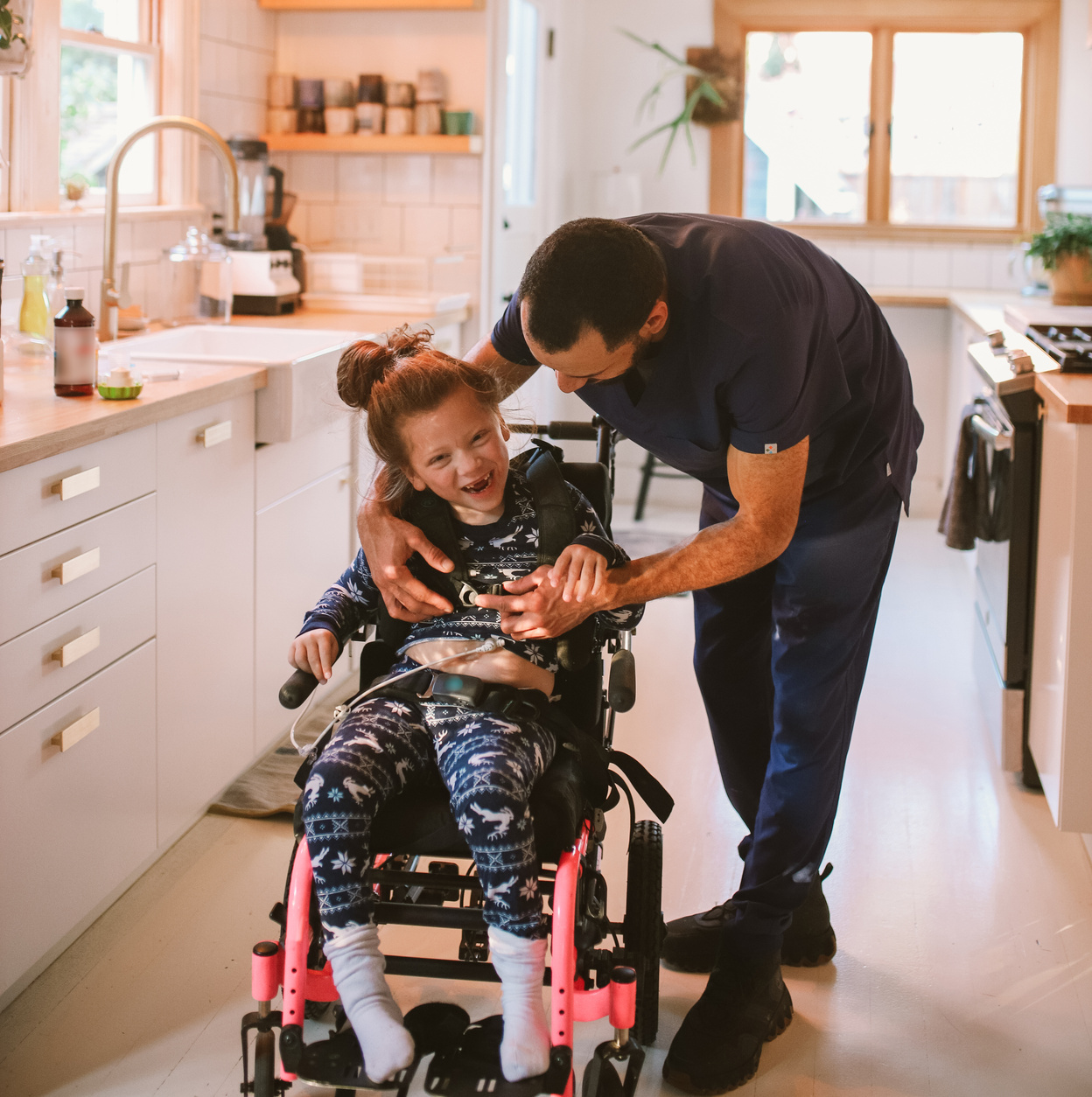 Home Nurse Taking Care of a Child with Cerebral Palsy 